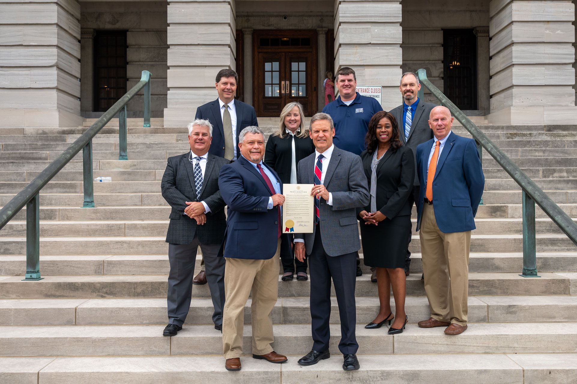 Tennessee Governor Bill Lee Proclaims October Cooperative Month<br />
(Front) Pictured with Governor Bill Lee representing the Tennessee Council of Cooperatives (TCC)  is Charlie Boring, TCC President representing Bledsoe Telephone Cooperative. (Middle) Todd Blocker, TCC Vice President Promotions and Outreach representing Tennessee Electric Cooperative Association; Arlisa Armstrong, Tennessee USDA Rural Development; Jimmy Ogilvie representing Tennessee Farmers Cooperative; (Back) Troy Dugger representing the Tennessee Center for Profitable Agriculture; Roberta Smith, TCC Administrative Secretary and Treasurer; Randy Stubblefield, TCC Vice President Policy and Operations representing United Farm and Home Cooperative; and Dan Strasser, TCC Vice President Education, representing Tennessee Farm Bureau Federation.